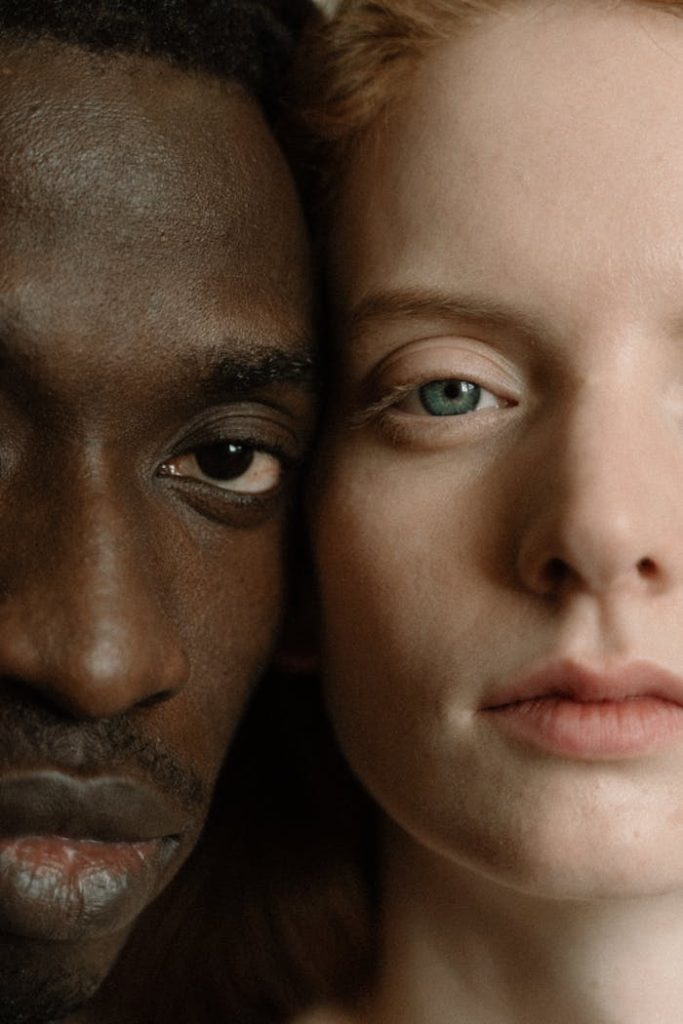 A close-up portrait capturing the diversity and intimacy of a couple embracing.